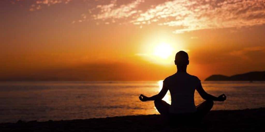 person meditating in a peaceful nature setting